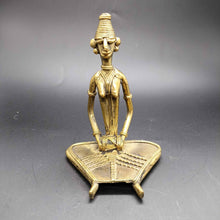 Dokra sitting musician with Dholak