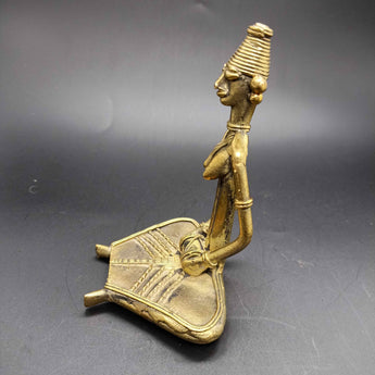 Dokra sitting musician with Dholak