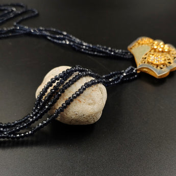 Black crystal beads necklace with ornate metal pendant