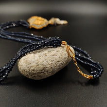 Black crystal beads necklace with ornate metal pendant